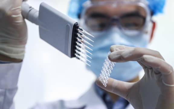 (200414) -- BEIJING, April 14, 2020 (Xinhua) -- A staff member tests samples of the COVID-19 inactivated vaccine at a vaccine production plant of China National Pharmaceutical Group (Sinopharm) in Beijing, capital of China, April 11, 2020.