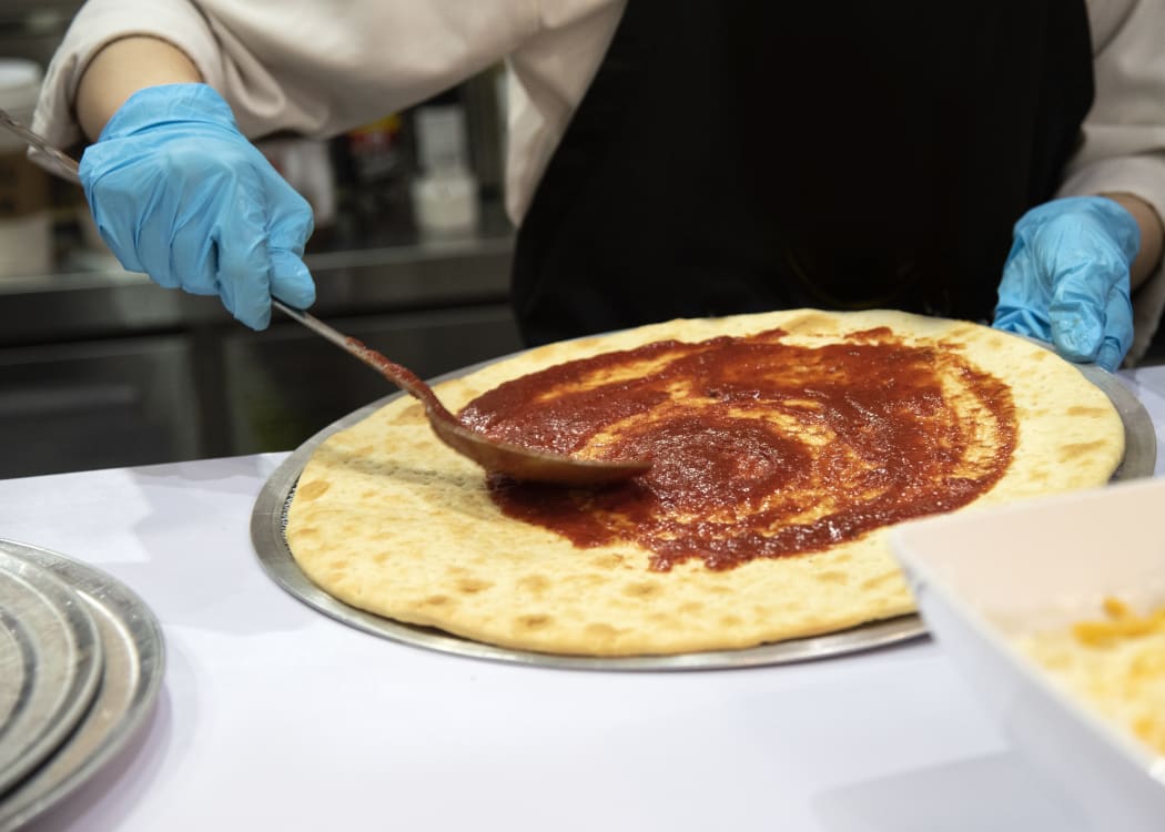 Pizza, fast food worker in kitchen, takeaway.