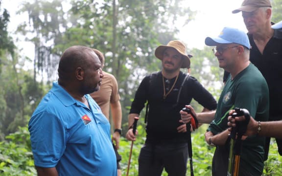 After flying into Kokoda Village on Tuesday, Albanese, right wearing blue cap, was embraced by Marape, left in blue t-shirt, and welcomed by the tribes of the Oro Province with a "sing-sing".
