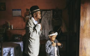 Dada Paul Rakotazandriny (91), who is living with dementia, and his granddaughter, Odliatemix Rafaraniriana (5), get ready for church on Sunday morning at his home in Antananarivo, Madagascar. 12 March 2023