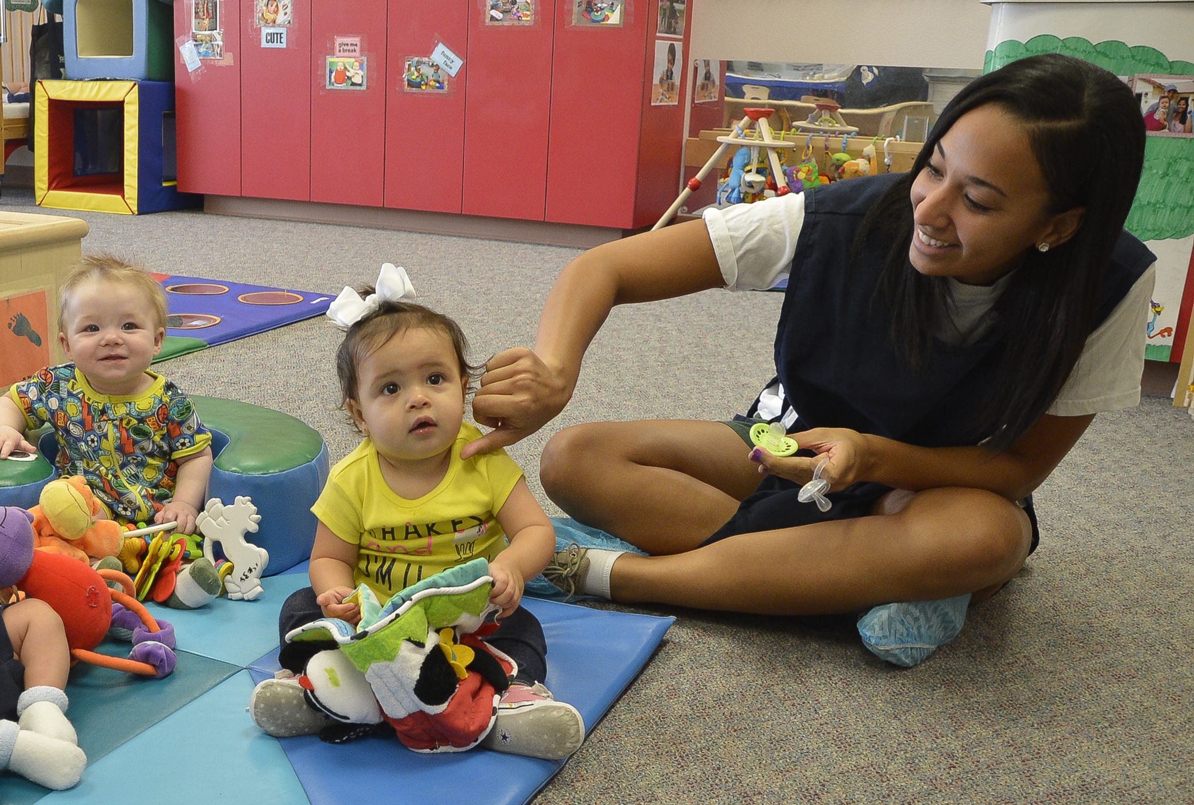 childcare teacher with 3 babies