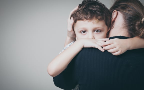 sad son hugging his mother