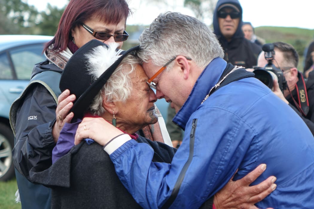 New Plymouth mayor Andrew Judd is embraced by Parihaka elder Te Whero o te Rangi Bailey after the peace hiko entered Parihaka.