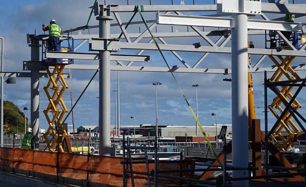 Building frame and man on scissor lift at  Wellington Airport