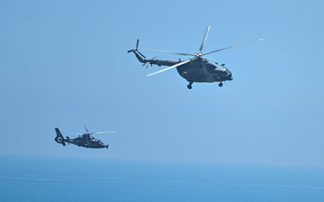 Chinese military helicopters fly past Pingtan island, one of mainland China's closest point from Taiwan, in Fujian province on August 4, 2022, ahead of massive military drills off Taiwan.