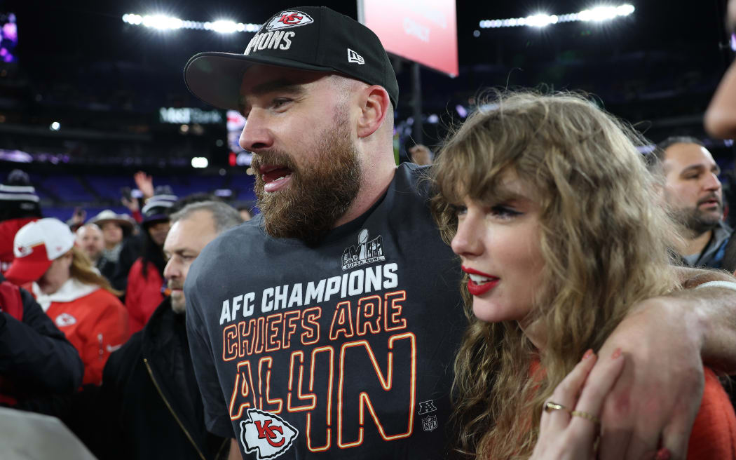 Travis Kelce #87 of the Kansas City Chiefs celebrates with Taylor Swift after a 17-10 victory against the Baltimore Ravens in the AFC Championship Game.