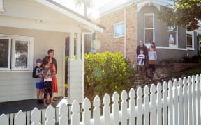 Michele Speir, Steve Botting and their children Leo and Issy, left, can only talk to their neighbours and friends the Lockie family (Tim, Bethany, Freddy and Gus) from afar