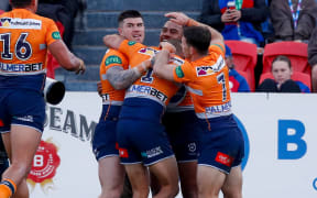 The Knights celebrate after Greg Marzhew scores. Newcastle Knights v One NZ Warriors.