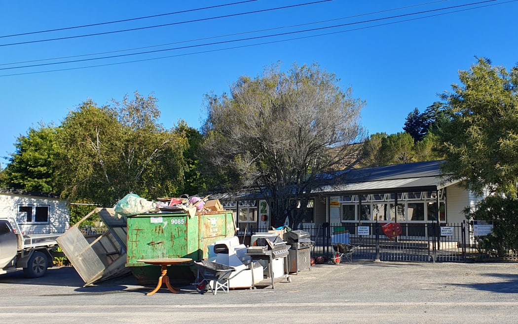 Rubbish outside Tīnui school after firefighters hosed silt from classes and the field