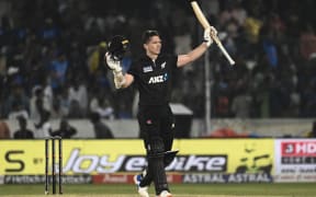New Zealand's Michael Bracewell celebrates after scoring a century during the first one-day international cricket match against India. 2023.