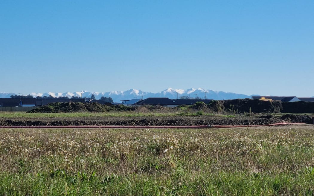 Land in the beginning stages of new housing development in Lincoln, Canterbury with the Southern Alps in the background.