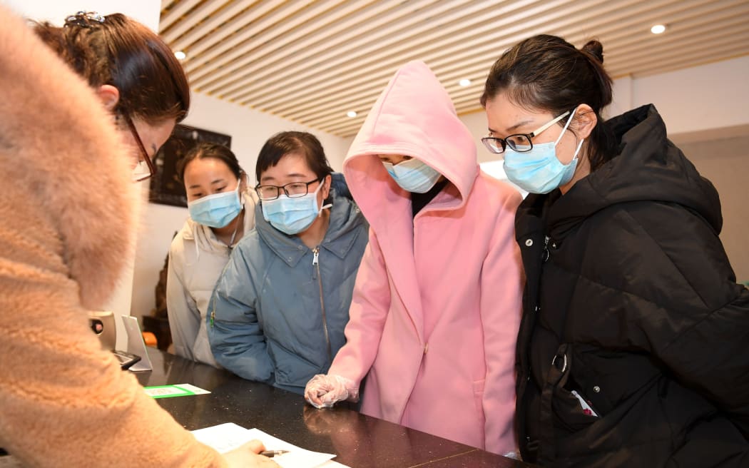 (200214) -- HEFEI, Feb. 14, 2020 (Xinhua) -- Health workers register at Yu Guojian's hotel in Hefei, capital of east China's Anhui Province, Feb. 14, 2020.