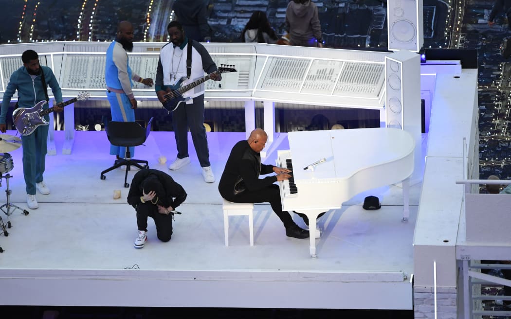 US rapper Eminem kneels on stage as he performs with Dr Dre during the halftime show of Super Bowl LVI in February 2022.