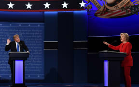 Republican presidential nominee Donald Trump, left, speaks as Democratic presidential nominee Hillary Clinton gestures at the debate at Hofstra University in Hempstead, New York.