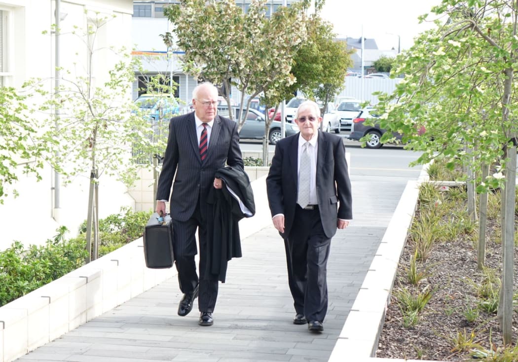 South Canterbury Finance former board member Robert White, right, on his way into court.
