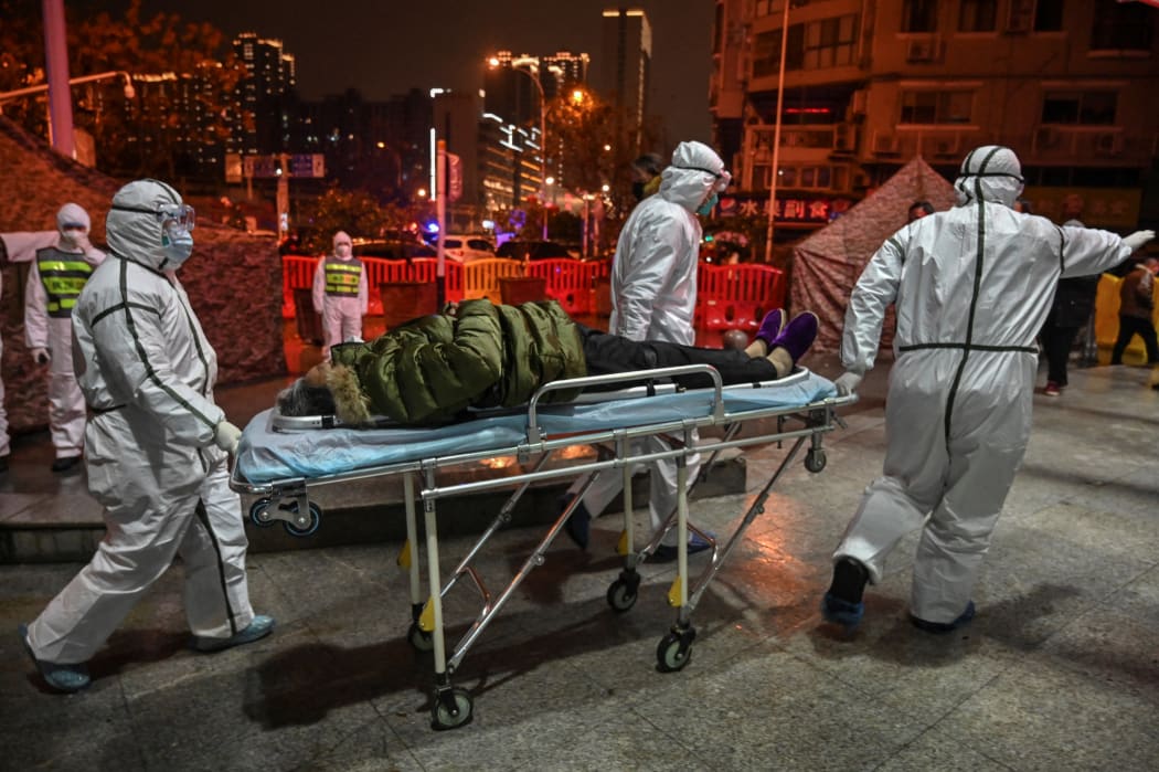 There is a "strong association" between the early outbreak and the sale of live animals in a market in Wuhan, scientists say. Medics arrive with a patient at the Wuhan Red Cross Hospital, 25 January 2020.
