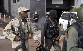 Malian troops take position outside the Radisson Blu hotel in Bamako