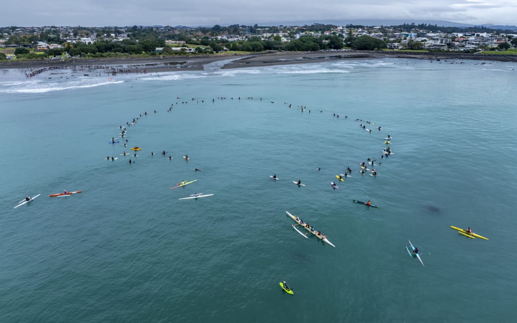Surfers, kayakers and waka ama paddlers were amongst the 130 who formed a circle off Autere East End Beach in Ngāmotu - one of nine community actions against seabed mining on Sunday.