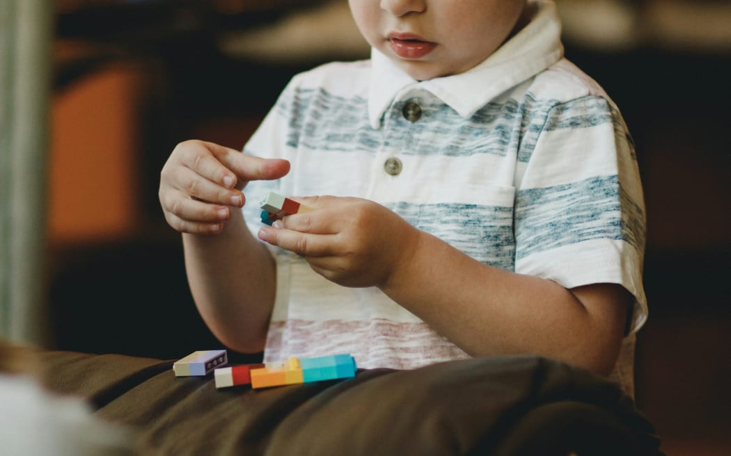 Child playing with blocks - young boy