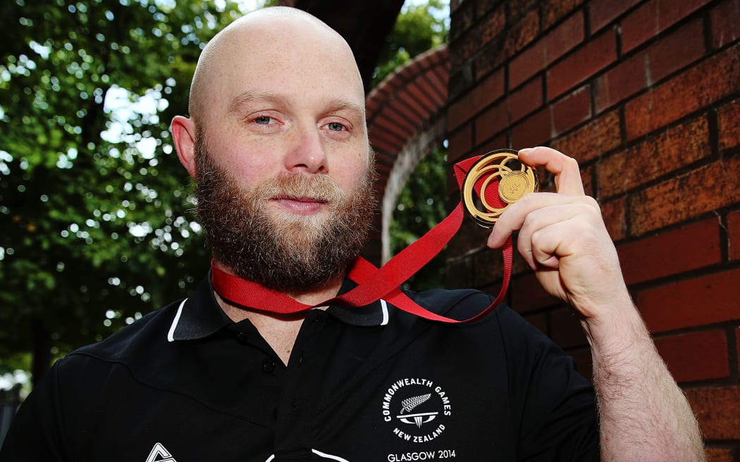 New Zealand Weightlifter Richard Patterson with his gold medal for the Mens 85kg class. Glasgow 2014 Commonwealth Games.