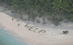 Stranded sailors on a deserted Pacific island used palm fronds to spell 'help'.