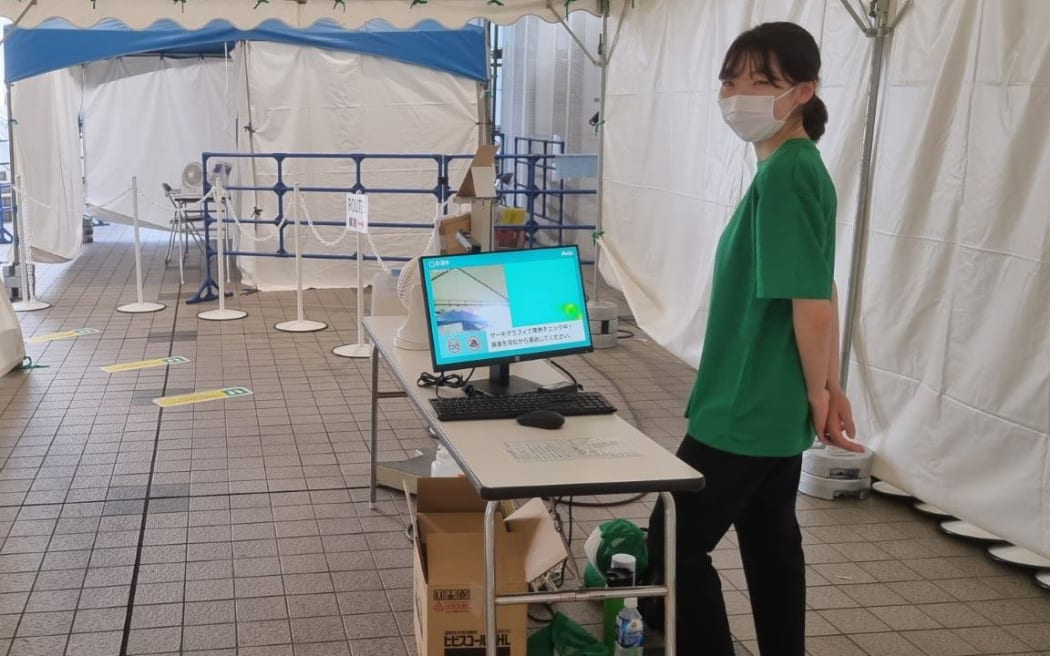 Covid-19 temperature screening during the security check at the Olympic venue.