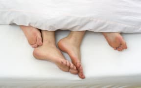 Bare feet of couple in bed (Photo by STOCK4B GMBH / Image Source / Image Source via AFP)