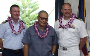 US Coast Guard official; Governor Lolo Matalasi Moliga; and  Commander Andy Strickland, Commanding Officer of the USS Shoup.