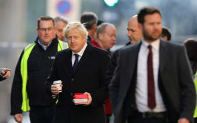 Britain's Prime Minister Boris Johnson (C) visits the scene of a stabbing, on London Bridge in the City of London on November 30, 2019.