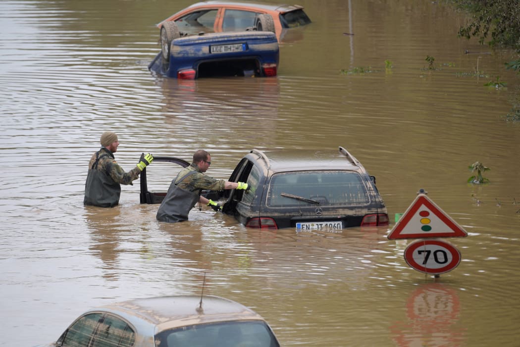 Soldiers of the German armed forces Bundeswehr search for flood victims in submerged vehicles on the federal highway B265 in Erftstadt.