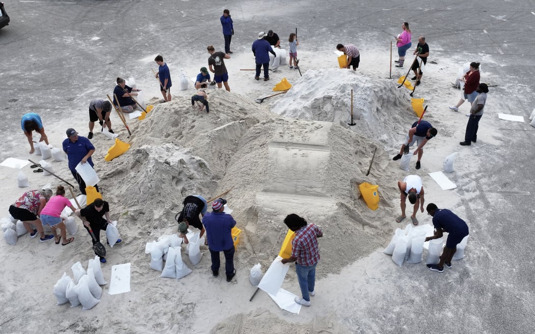 People fill sandbags at Helen Howarth Park ahead of Hurricane Helene, on 25 September, 2024 in Pinellas Park, Florida.