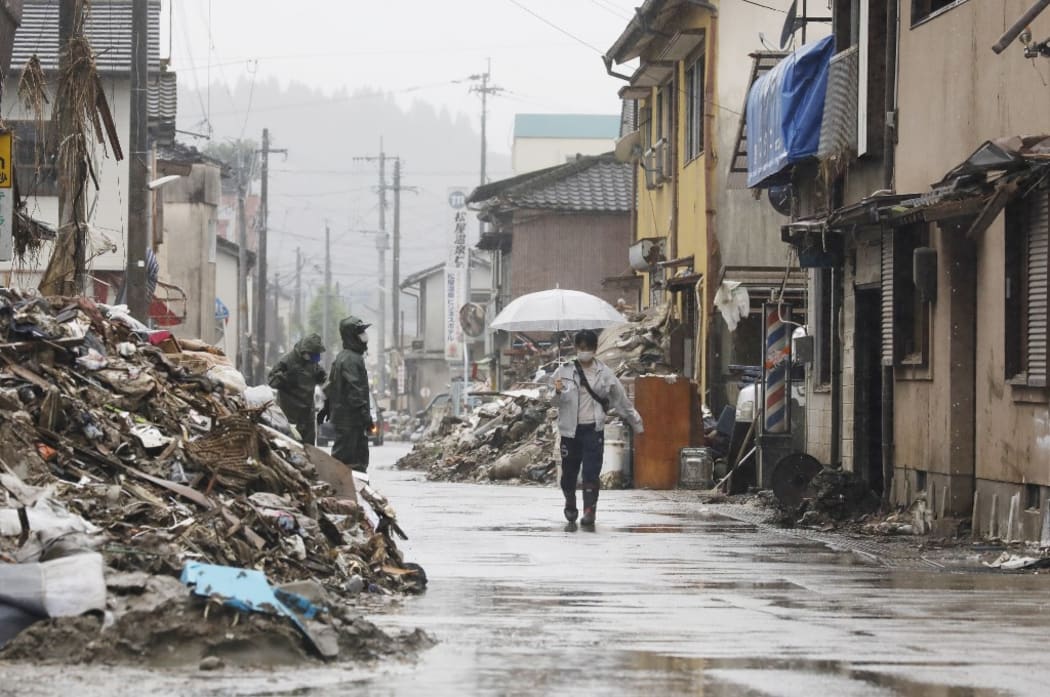 Residents remove debris and conduct a restoration work in Hitoyoshi, Kumamoto Prefecture. The torrential rain that triggered landslides and flooding occurred on July 4th.