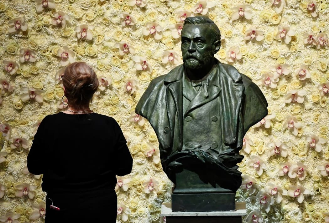 (FILES) In this file photo taken on December 10, 2019 a visitor stands in front of a bust of the Nobel Prize founder, Alfred Nobel prior the Nobel awards ceremony  at the Concert Hall in Stockholm, Sweden.