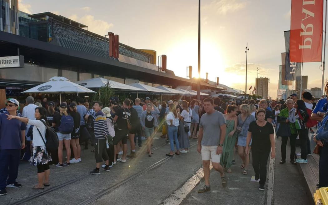 America's Cup fans walk along the Auckland viaduct after Team New Zealand's trophy presentation.
