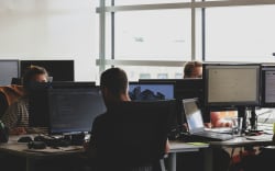 Workers at desks in an office.