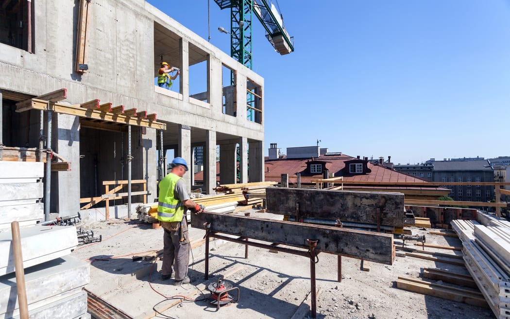 workers with power tools on the building site