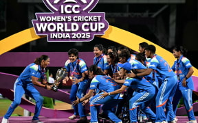 India’s players celebrate with the trophy after winning the ICC Women's Cricket World Cup.