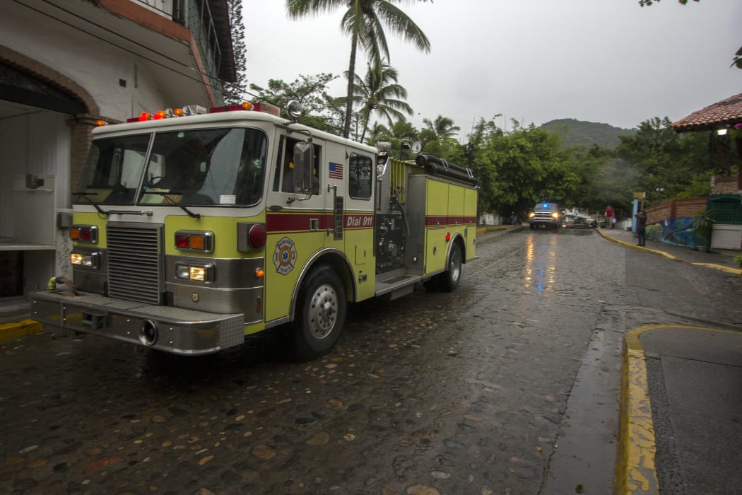 Firemen assemble ahead of the storm.