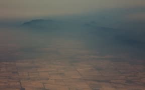 Smoke and haze over mountains seen from an Australian air force aircraft assessing damage in the area from bushfires, in Cooma in New South Wales on 7 January, 2020.