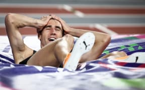 New Zealander Hamish Kerr celebrates after winning the men's high jump final during the Indoor World Athletics Championships in Glasgow, Scotland, 2024.