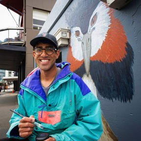 Kiran Parbhu in front of one of his murals