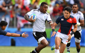 Fiji's Josua Tuisova runs with the ball against Japan.