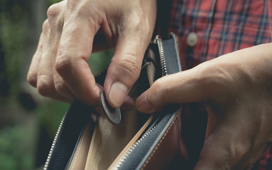 Close-up woman standing and holding money coin with wallet empty of money