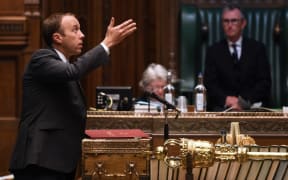 A handout photograph released by the UK Parliament shows Britain's Health Secretary Matt Hancock speaking in the House of Commons in London .