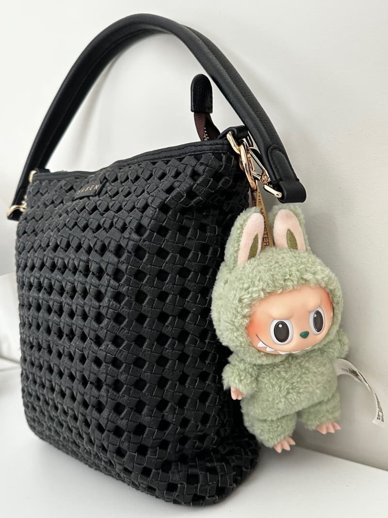 A collectible Labubu plush pendant on Jasmine Kim's handbag.