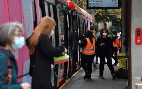 Passengers wearing face masks alight from a metro in Sydney on June 23, 2021, as residents were largely banned from leaving the city to stop a growing outbreak of the highly contagious Delta Covid-19 variant spreading to other regions.