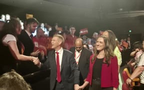 Labour leader Chris Hipkins shook people's hands as he walked out of the theatre hand in hand with his fiancé Toni Grace.