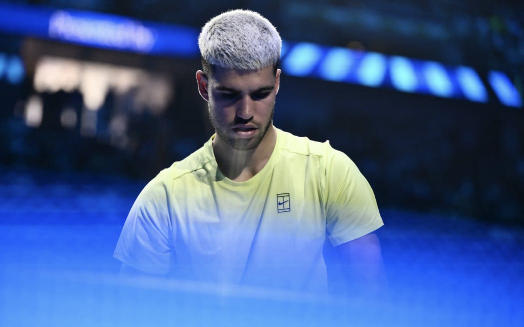 Spain's Carlos Alcaraz enters the court prior the match against USA's Taylor Fritz during the ATP Finals tennis tournament in Turin on November 11, 2025. (Photo by Marco BERTORELLO / AFP)