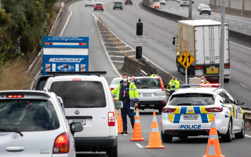 Police check motorists going on motorway in Auckland the day before the Easter long weekend begins.