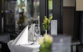 Elegant table setting at a sidewalk cafe, awaiting guests. (Photo by Pancake Pictures / Image Source / Image Source via AFP)